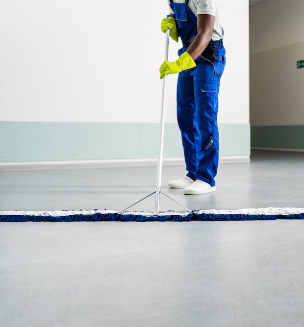 man cleaning floor with mop